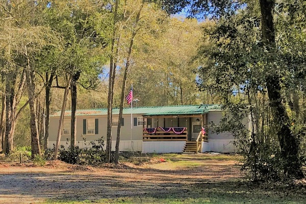 Secluded but only 2 miles from Live Oak on a paved road.