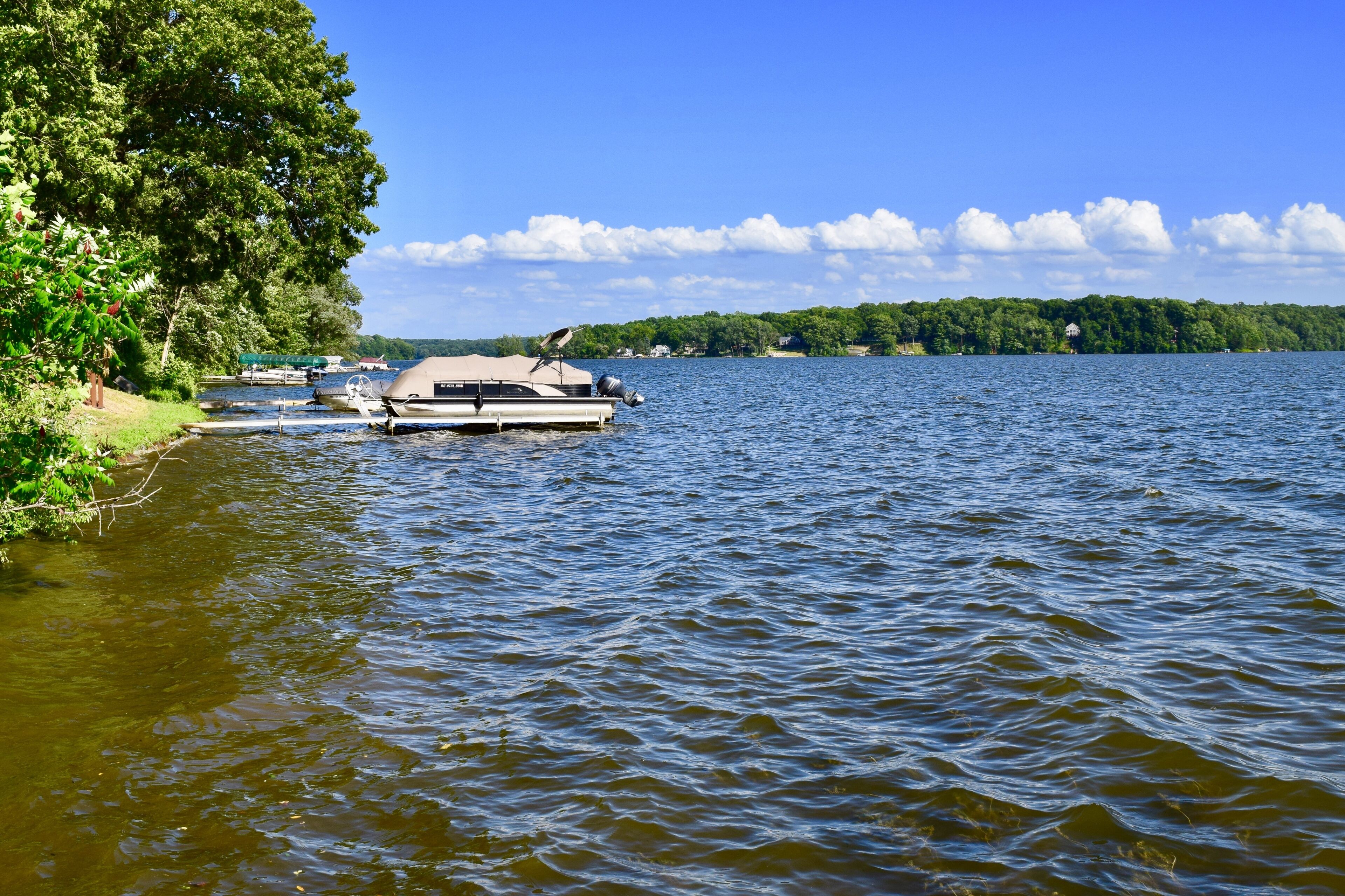 A lake with a dock and a boat.