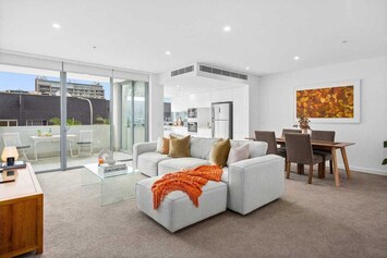 Large open plan living and dining area with comfy lounge, TV and dining for 4