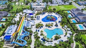 An aerial view of a resort with a central pool, a water park, and multiple guest villas. - 10BR Unique Encore Villa | Water Park & Pool (Kissimmee)