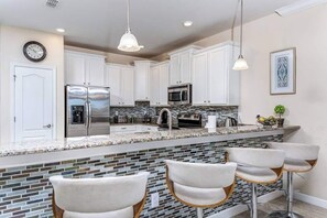 Fridge, microwave, oven, stovetop - Spacious 8-bedroom resort home with private pool, game room & theater. Access to Oasis Club. (Davenport)