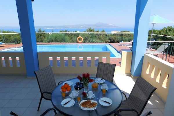 Villa Maria shaded dining area with sea view.