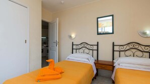 A hotel room with two beds, a bathroom, and a kitchenette. - Santa Maria 88 - Two Bed (Costa Adeje)