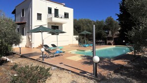 A two-story building with a swimming pool, outdoor seating, and a garden area. - A Recently Refurbed 3 Bedrm Villa, Large Pool, Great Privacy, Close to Amenities (Chania)