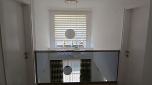 A room with a large window, a ceiling light, and a view of the outside. - luxury villa for rent city D (fethiye)