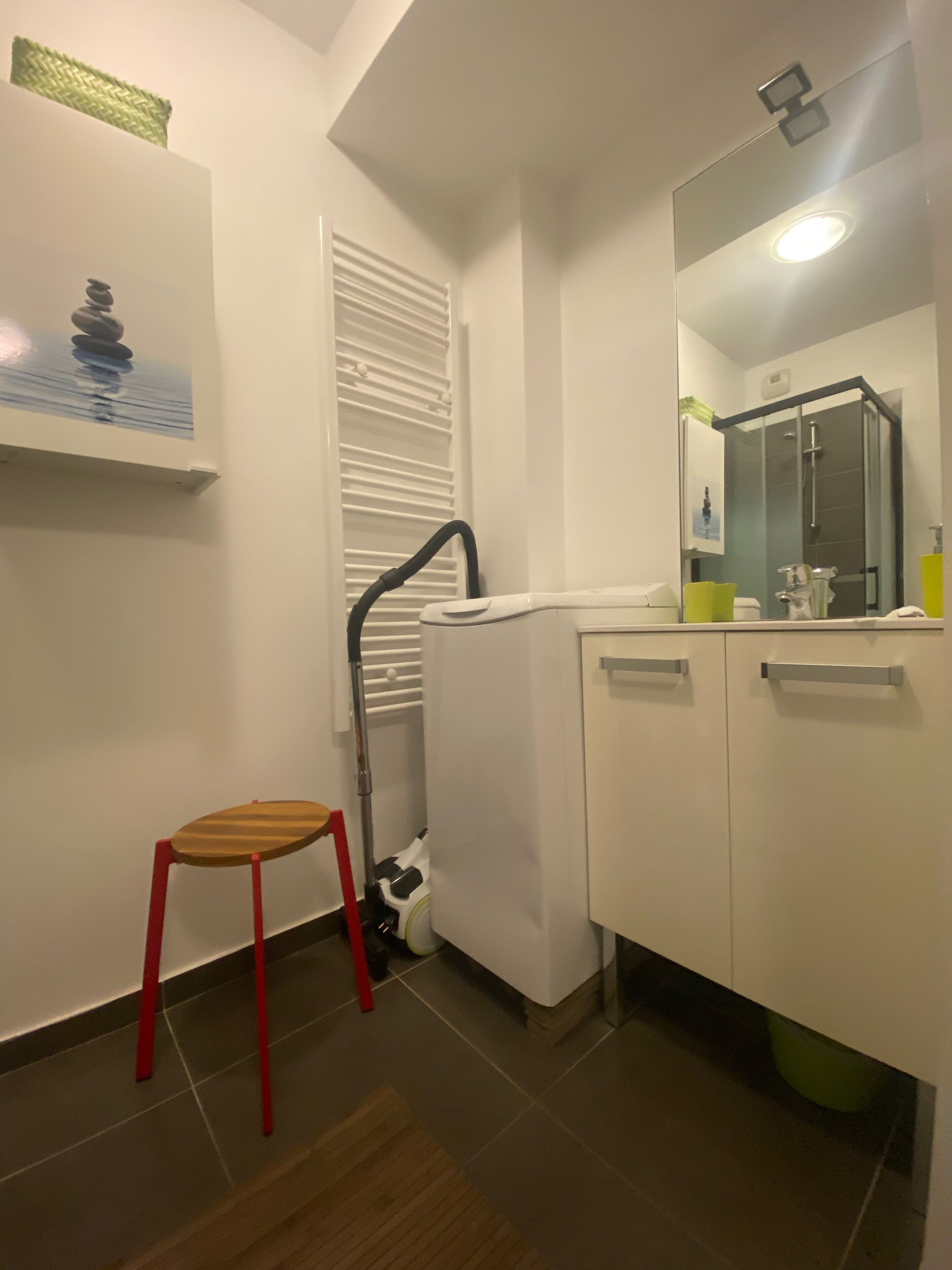 A bathroom with a shower, a toilet, a sink, and a mirror.