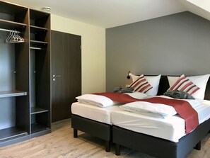 Relax in a stylish room with a large bed, wardrobe, and ample storage.