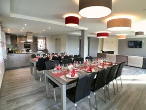 Enjoy meals in this dining area with a long table and comfortable seating for all.