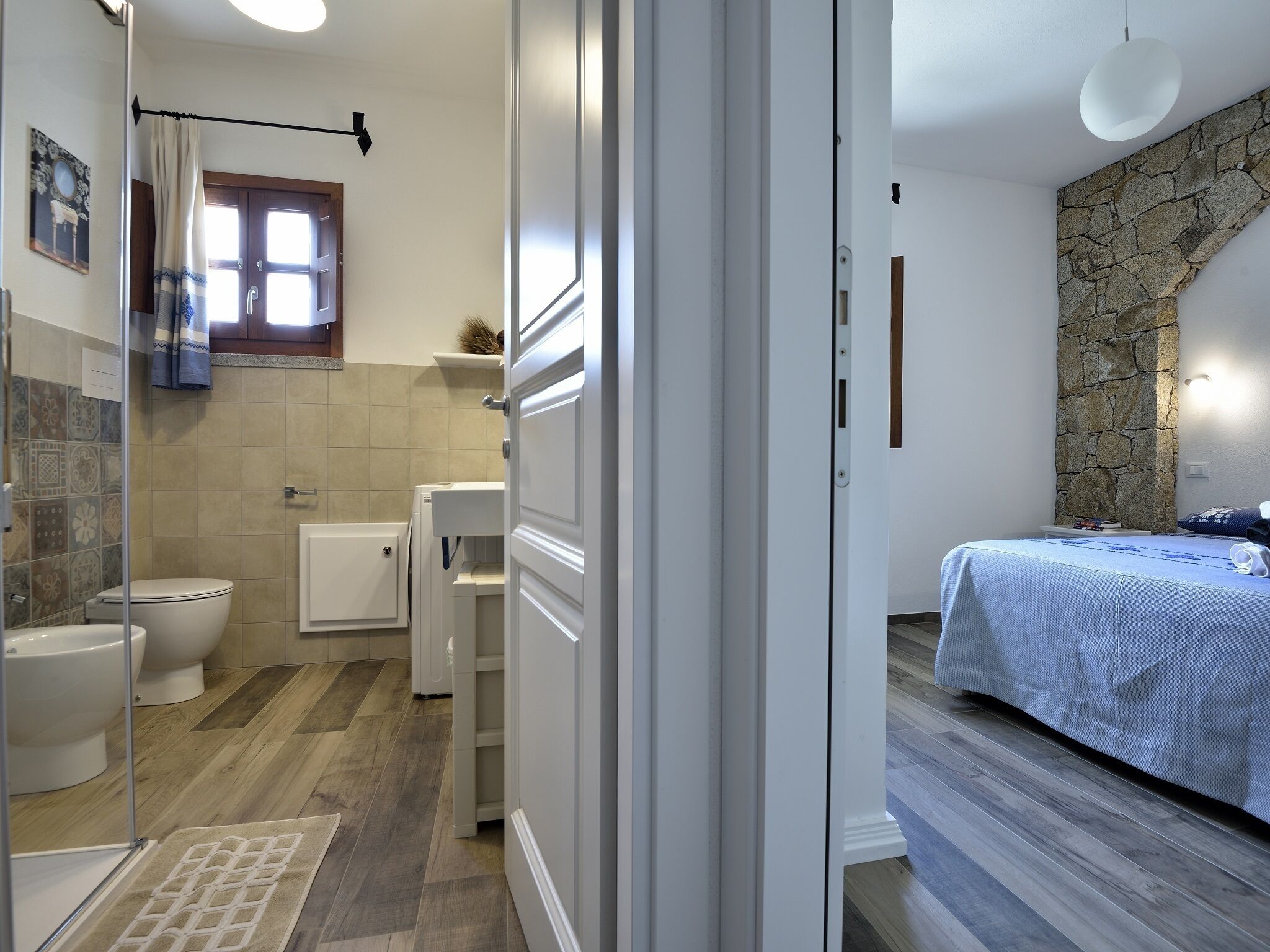 Bedroom with double bed, veranda with view