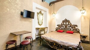 A bedroom with a bed, a desk, a chair, and a TV. - Apart-Hotel Kraft (Lviv)