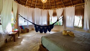 A room with a hammock, a bed, a small table, and a window with curtains. - Villa/Boutique 4 BDR VIP Concierge/Chef in la Veleta Tulum (La Veleta Tulum)