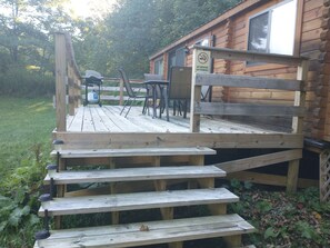 Step out onto the deck and enjoy the view from this cabin's outdoor space.