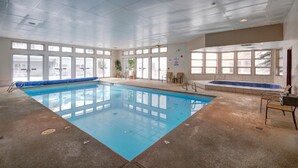 An indoor swimming pool with clear blue water, surrounded by windows and chairs. - Big 2Br/2 Bath Condo (1443 Sq. Ft.; 2 Living Rooms; Sleeps 10); Walk To Lifts. (Keystone)