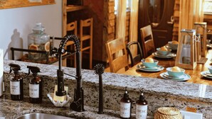 A kitchen counter with various cleaning supplies, a hand soap dispenser, and a woven basket. - Casa del Ojo - 3 King beds - Heated Pool - BBQ - 1 mile to downtown FTL (Fort Lauderdale)