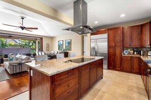 Enjoy cooking in this well-equipped kitchen with a large island, refrigerator, and dishwasher.