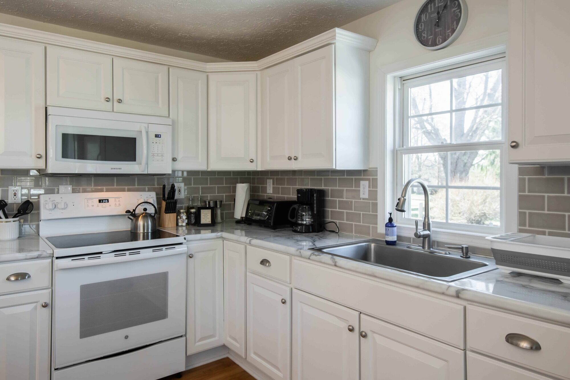 Classic white farmhouse style cottage. Perfect for a serene country getaway.