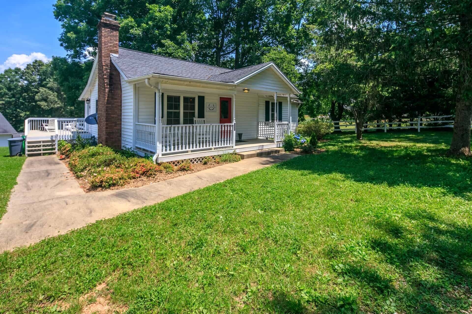 Classic white farmhouse style cottage. Perfect for a serene country getaway.
