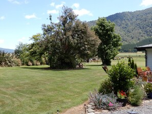 Surrounded by lush gardens and a mountain range, this serene setting offers a peaceful escape.