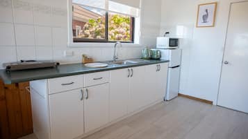 Fridge, coffee/tea maker, cookware/dishes/utensils