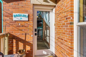 A brick building with a sign reading "BONANZA" and a door leading to an interior space.