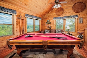 A wooden interior with a pool table, a ceiling fan, and a window with blinds. - 🏔️ Heaven's Garden🌲Mt LeConte Views, HotTub, near Dollywood (Sevierville)