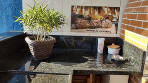 A kitchen counter with a potted plant, a ceramic cup, and a metal dish. - Farm in Socorro wi-fi, solar heated pool, hot tub  (Socorro)