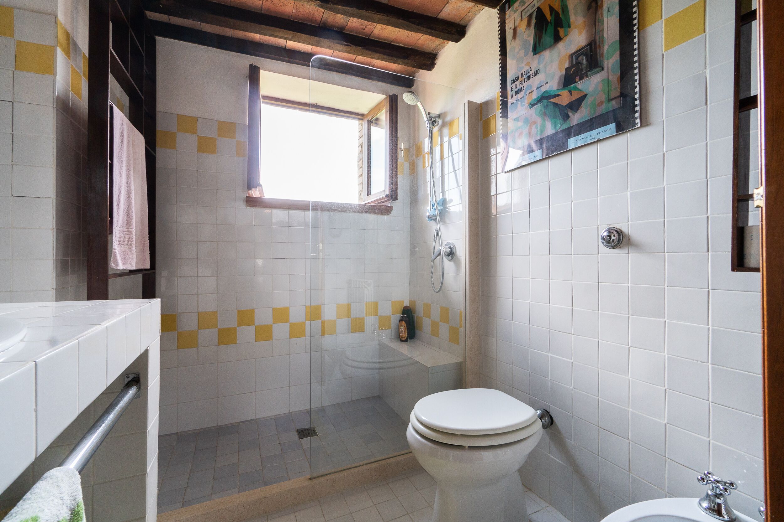 A bathroom with a toilet, a shower, and a sink.