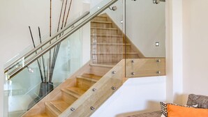 A modern staircase with glass railings and wooden steps. - 52 Esplanade - Luxury - Seafront - Wi-Fi (Middleton)