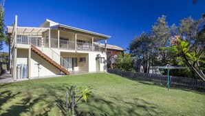 A two-story house with a balcony, a staircase, and a fenced backyard. - Mitchellmook in Mollymook (Mollymook Beach)