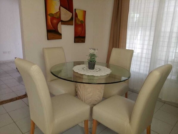 Enjoy meals in this elegant dining area with a round table and comfortable chairs.