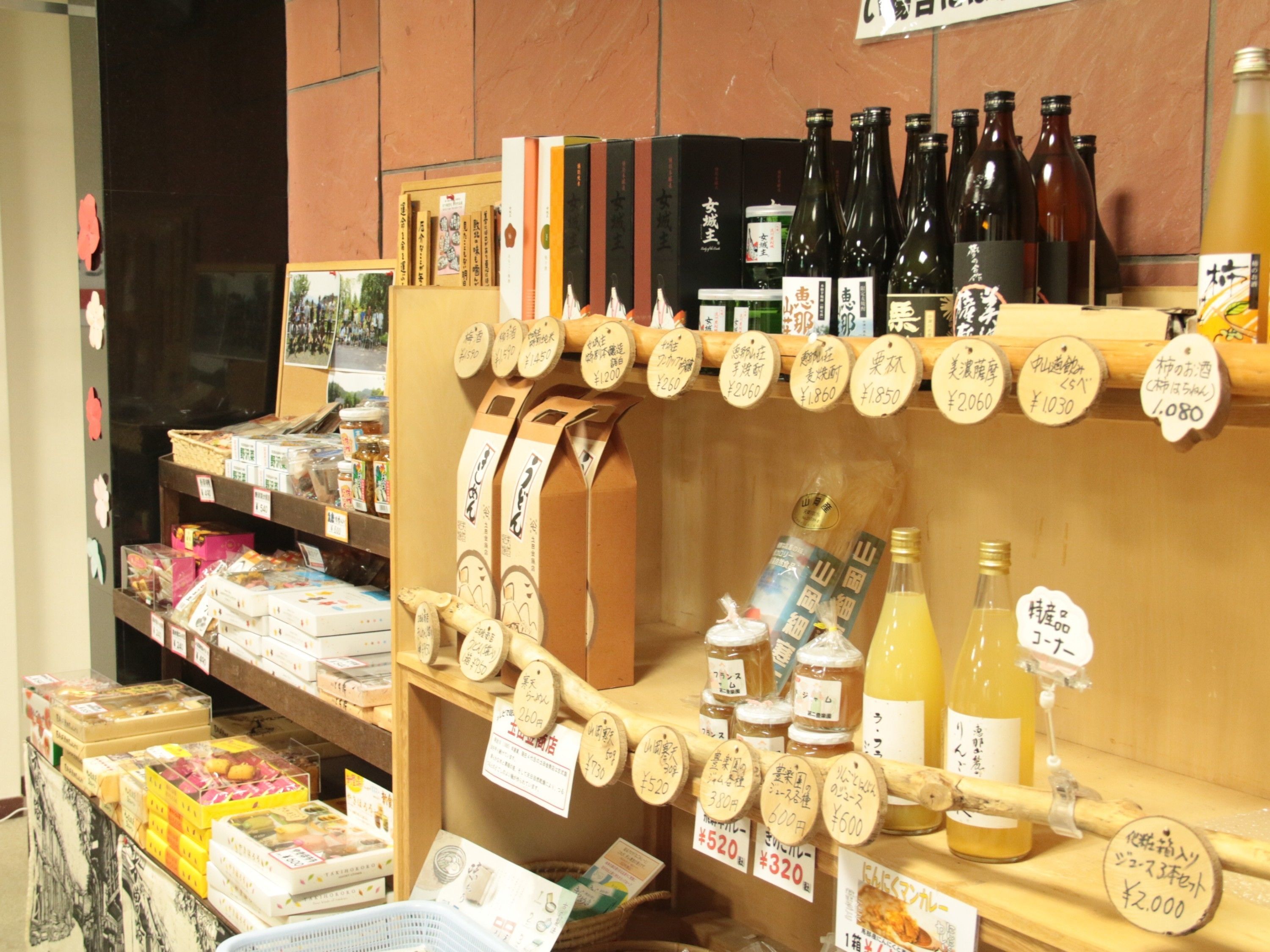 A bookstore with shelves of books and a display of various bottles.