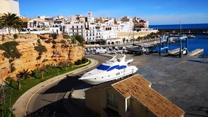 A coastal town with a marina, white buildings, and a large yacht docked at the pier. - Nice house for 8 people with private pool, wifi and 400m from the sea. (Ametlla de mar)