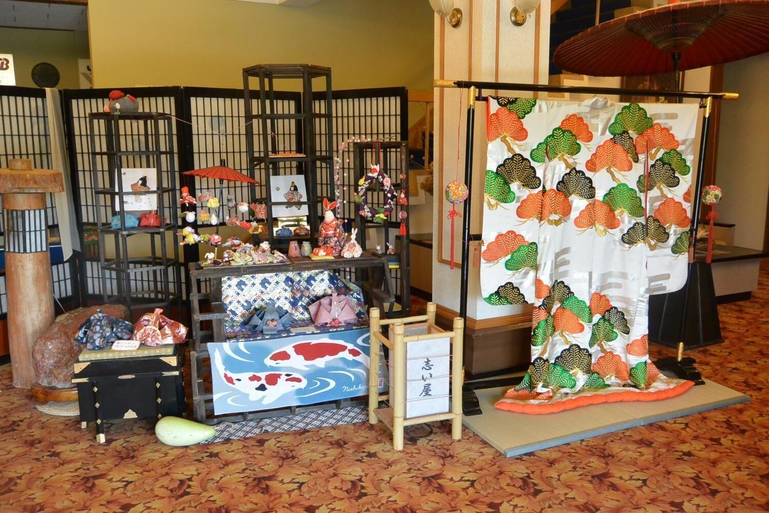 A traditional Japanese room with tatami flooring, a shoji screen, and various cultural decorations.