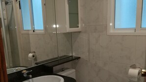 A bathroom with a white sink, a toilet, and a mirror above the sink. - Apartment for groups in Logroño (Logroño)