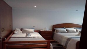 A bedroom with a wooden bed, a nightstand, and a wardrobe.