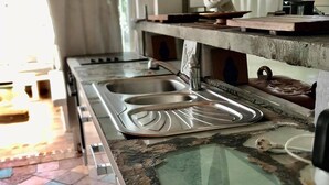Une cuisine dotée d’un grand plan de travail, de deux éviers et d’une cuisinière.