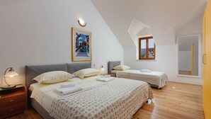 A bedroom with two beds, a large window, and a painting on the wall. - Secluded Villa Dubrava, private pool, olive grove surrounds the villa, Brac Island (Pučišća)