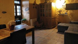 A rustic room with a wooden table, a cabinet, and a sofa. - Rural house (full rental) Finca Los Ciruelos for 2 people (Icod de los Vinos)
