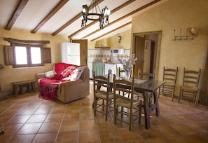 Relax in this inviting living room with a sofa, dining area, and kitchen.