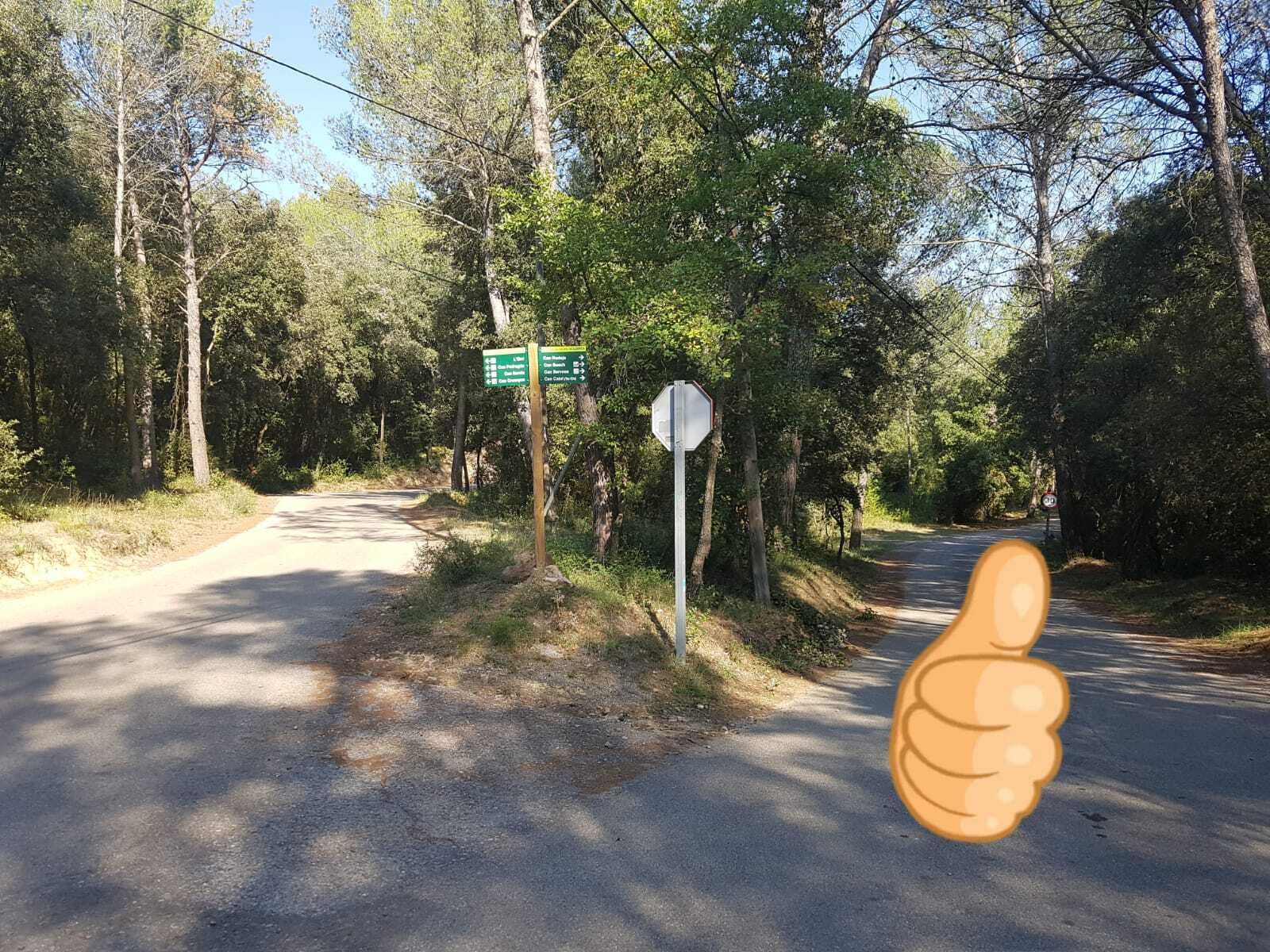 A road with directional signs and a thumbs-up graphic.