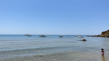 On the beach, sun-loungers