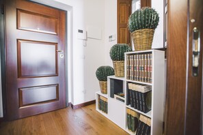 Stylish hallway with a modern electronic lock and intercom system, leading to a space.