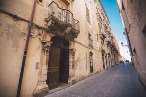 Stroll through historic streets lined with ornate buildings featuring arched windows and balconies.