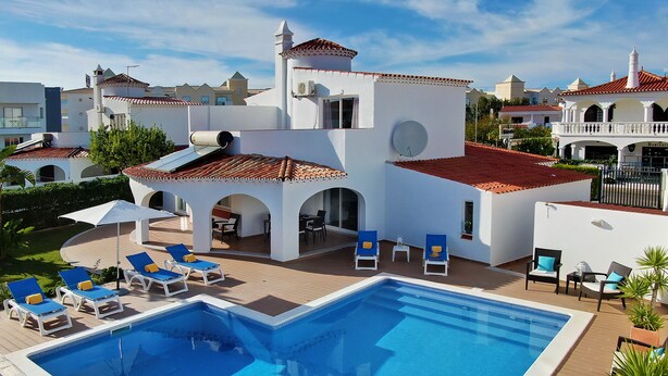 A swimming pool with lounge chairs and a patio area.