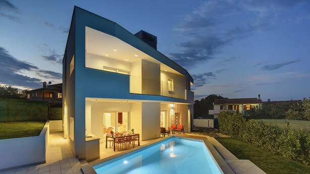 A modern two-story house with a swimming pool, outdoor seating, and a well-lit patio area. - Beautiful brand new villa ***** with heated swimming pool, summer kitchen, WiFi, grill (Pula)