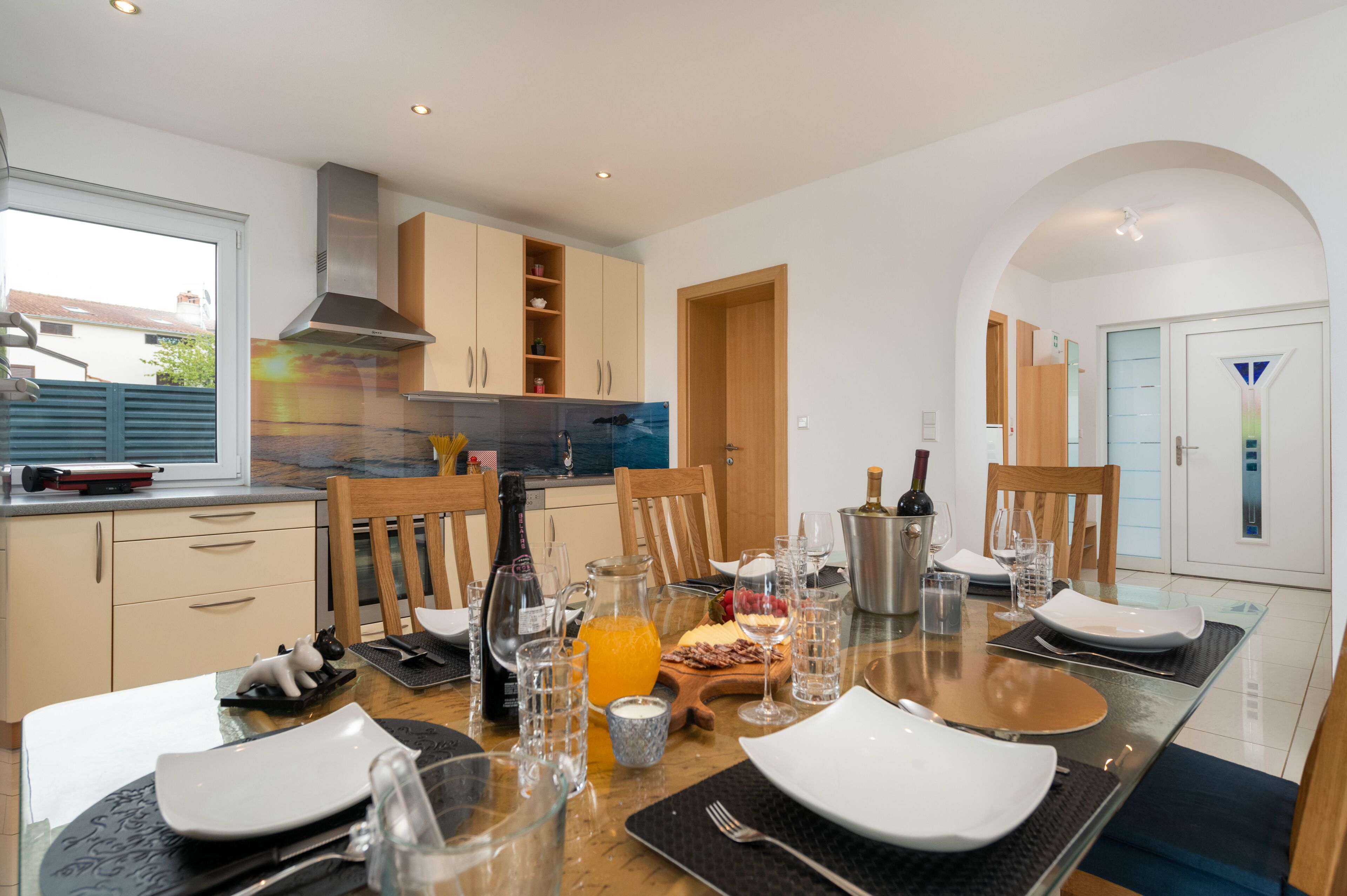 A modern kitchen with a dining area set for a meal.
