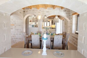 Enjoy meals in this charming dining area with a central table and comfortable seating.