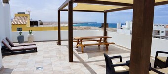 Chic apartment with sea views on a sandy beach, large roof terrace and WiFi