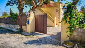 A gated entrance with a staircase leading to a building, surrounded by trees and a stone wall. - Stylish Finca Julia with 1000 sqm garden, priv. Pool, Air, BBQ, fireplace, terrace (Denia)