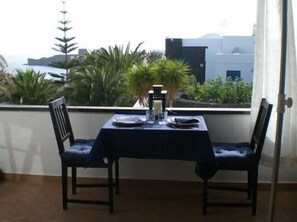 Enjoy a romantic dinner for two with a view of the sea from this intimate dining area.